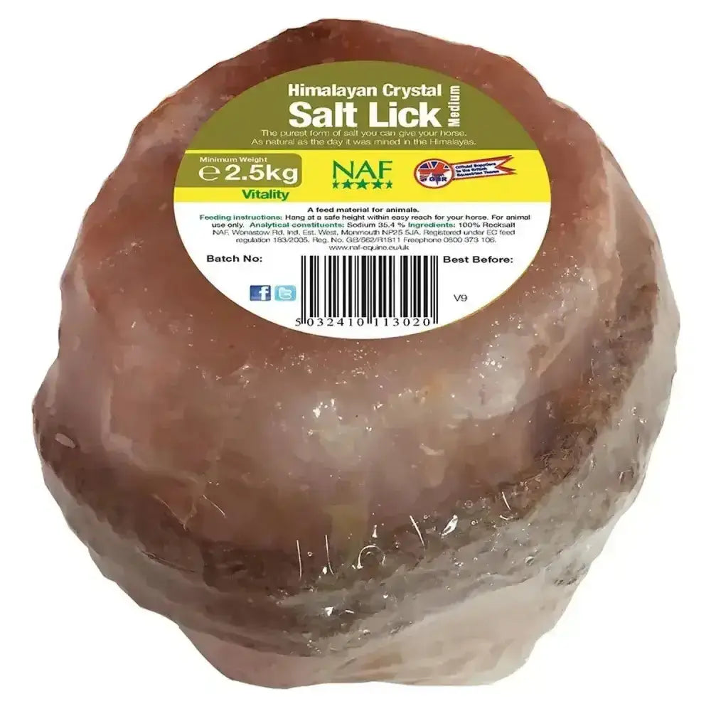 A round translucent pinkish-brown naf himalayan salt lick with a textured surface and vitality label for natural rock salt use