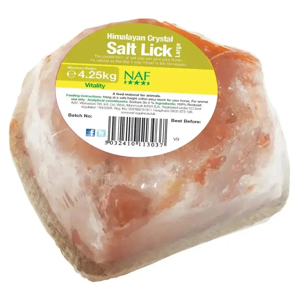 A large irregular naf himalayan salt lick with pinkish-orange natural rock salt crystals in clear plastic wrap
