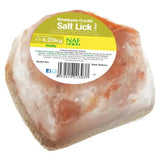 A large irregular naf himalayan salt lick with pinkish-orange natural rock salt crystals in clear plastic wrap