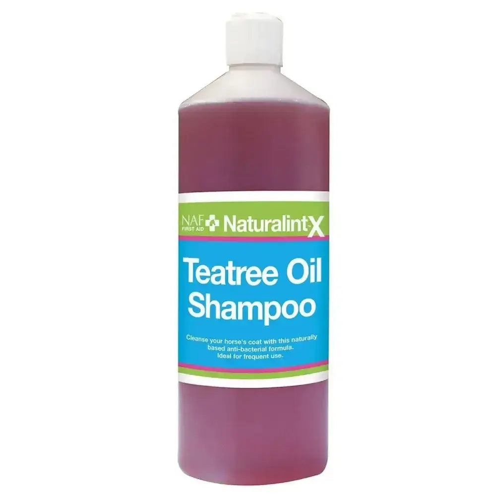 A clear plastic bottle with white cap contains purple antibacterial naf naturalintx tea tree oil shampoo labeled naf naturalintx
