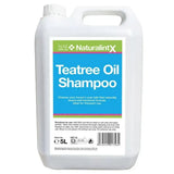 White plastic jug of naf naturalintx tea tree oil shampoo antibacterial 5-liter container with handle and screw cap