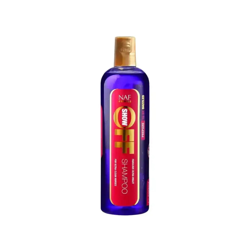 A vibrant blue naf show off horse shampoo bottle with gold cap and red label cleans deeper and shines brighter