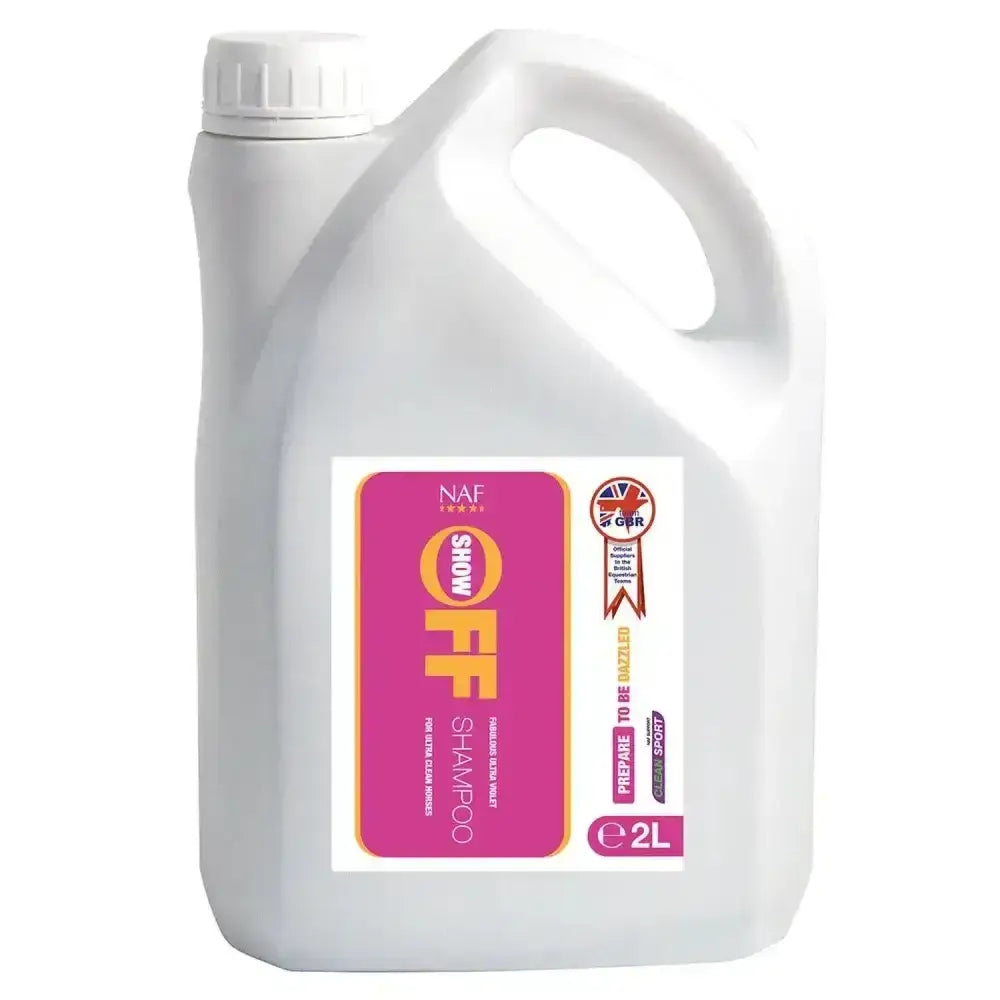 White plastic 2 liter jug of naf show off shampoo with pink and yellow label cleans deeper and shines brighter for horses