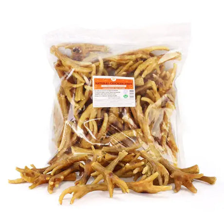 A clear plastic bag filled with natural light brown chicken feet for dog treats paddock farm chicken feet 1kg