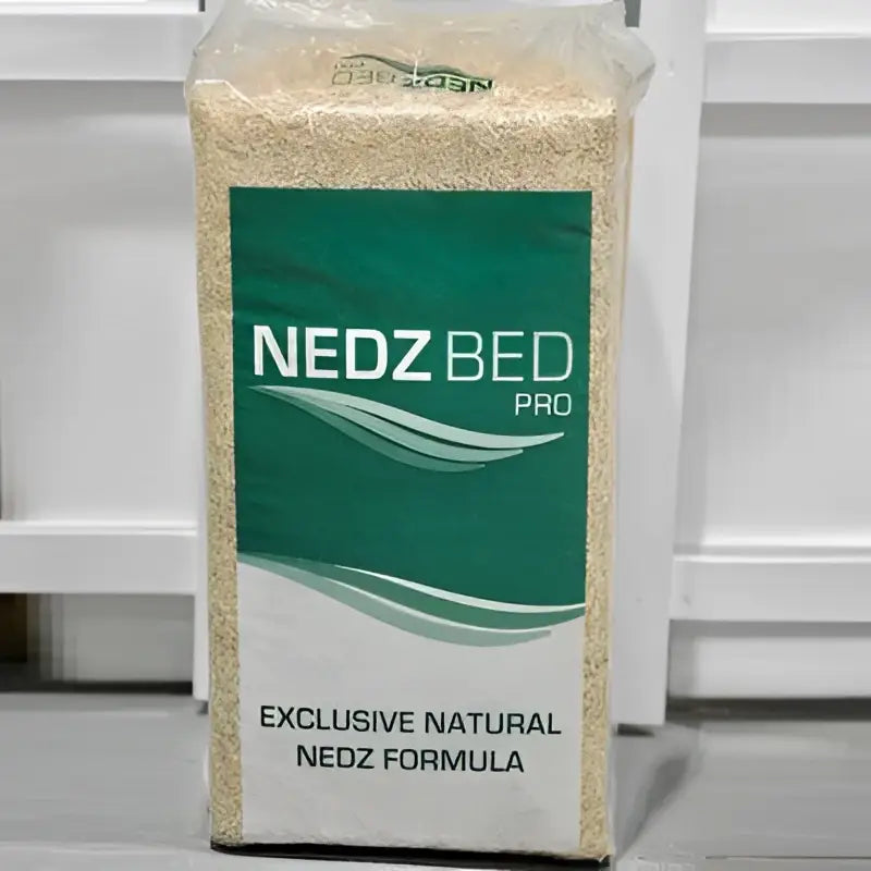 A 20 kg bag of nedz bed pro bedding material with a green and white label exclusive natural nedz formula