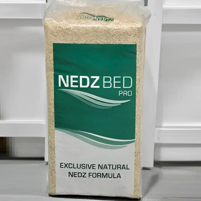 A 20 kg bag of nedz bed pro bedding material with a green and white label exclusive natural nedz formula