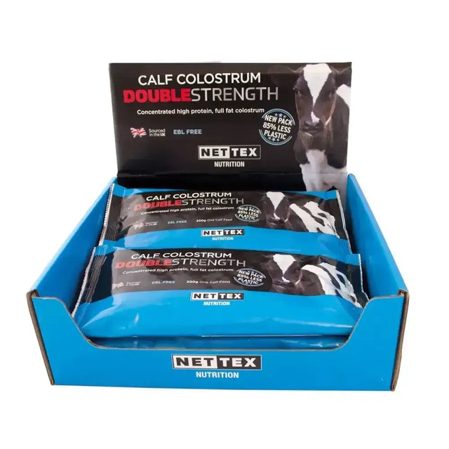 Blue cardboard display box with nettex agri calf colostrum double strength fat colostrum supplement bars inside