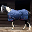 Horse in a blue blanket with red trim featuring Gallop Trojan 50g Stable Rug Lightweight