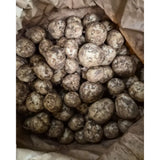 A pile of new potatoes with earthy brown skin perfect for healthy meals after a day of equestrian activities