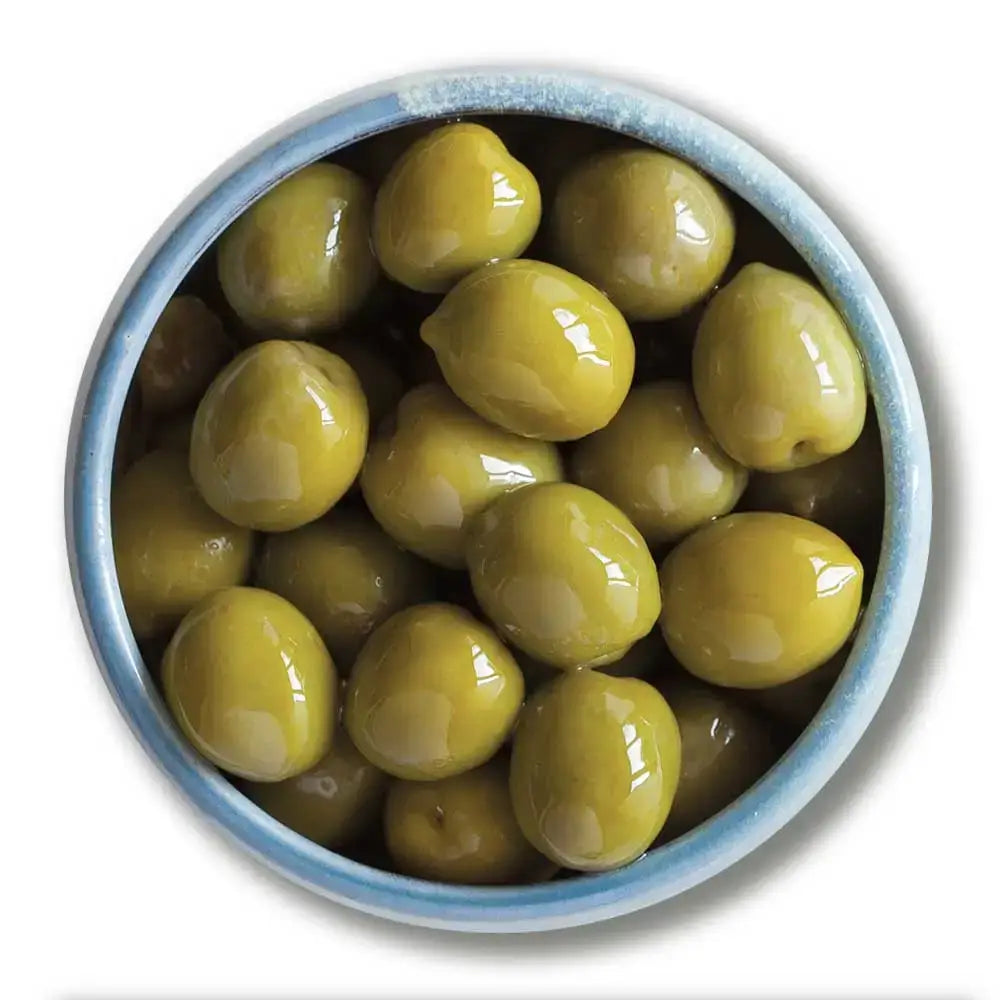 A bowl of glossy nocellara del belice whole green olives in a light blue ceramic dish perfect for stuffed green olives snacks
