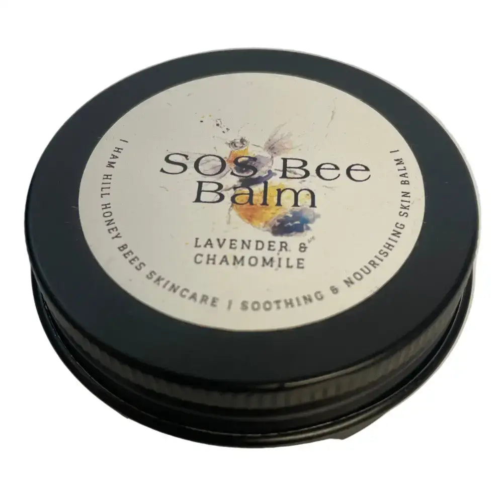 Black round tin of north devon honey luxury beeswax sos bee balm with lavender chamomile for skin care