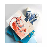 Notebook competition horse featuring a peach-colored competition horse with black bridle and red mane details design