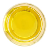Clear glass bowl filled with golden yellow omega equine ultra oil made from sea buckthorn oil for horses