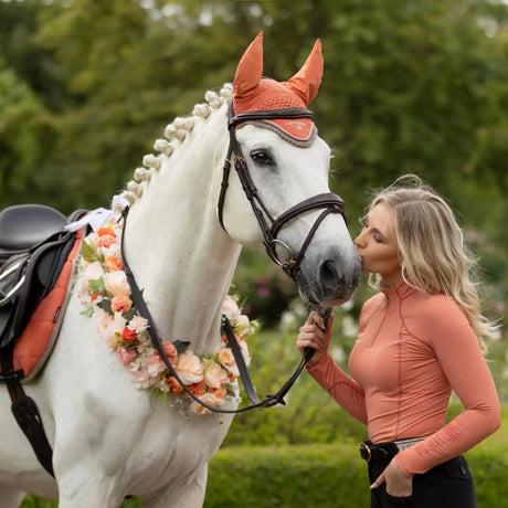 Orange woven ear bonnet with a decorative silver trim.