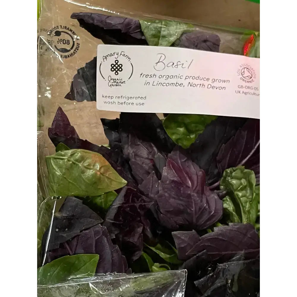 A package of organic basil with mixed purple and green leaves in a clear bag from an organically certified farm
