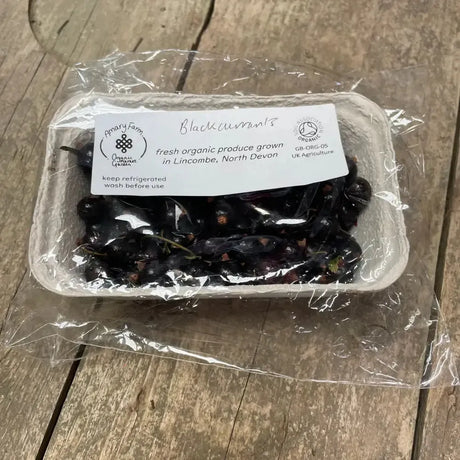 A clear plastic-wrapped package of organic blackcurrants from amary farm grown in lincombe north devon great for equestrian horses