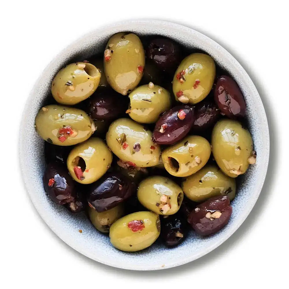 A bowl of organic chilli cumin and garlic pitted olives with green olives and red pepper flakes for a spicy kick
