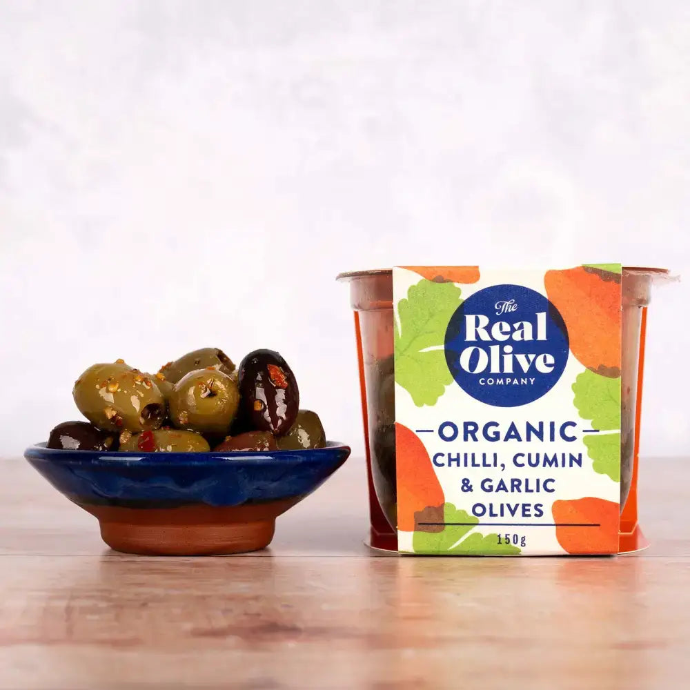 A vibrant package of real olive company organic chilli cumin and garlic pitted green olives perfect for snacking