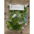 A clear plastic bag filled with fresh vibrant green organic mint leaves from an organically certified farm