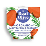 The real olive company organic smoky paprika and rosemary grilled olives in white heart container with orange olive illustrations