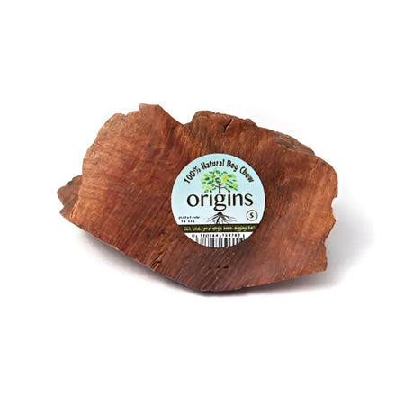 A rustic reddish-brown wooden origins root chews small dog chew toy with a circular white label 150g - 300g