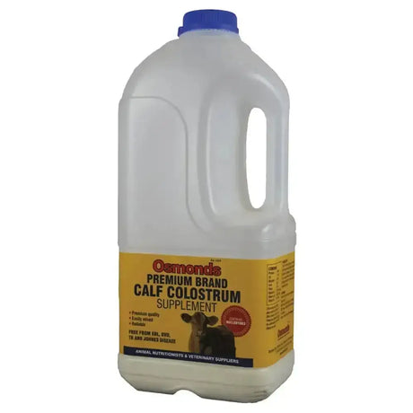 A translucent plastic jug with a blue cap yellow label of osmonds premium brand calf colostrum easily mixed powder supplement