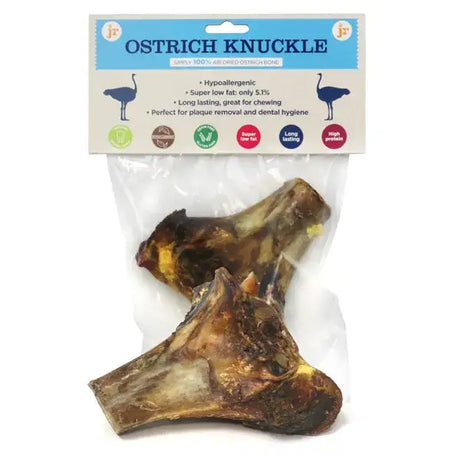 Two dark brown dried ostrich knuckle bones in a clear bag labeled ostrich knuckle bone dog treats