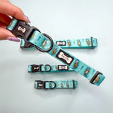 Teal lovely dog collar with cartoon otters pattern and black buckle hardware perfect for otterly lovely dog lovers