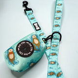 Teal fabric otterly lovely poo bag holder with otter print and black metal hardware for stress-free cleanups and easy access