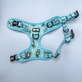 A light blue otterly lovely step-in dog harness with sea otter print and black plastic buckles for pup chic style