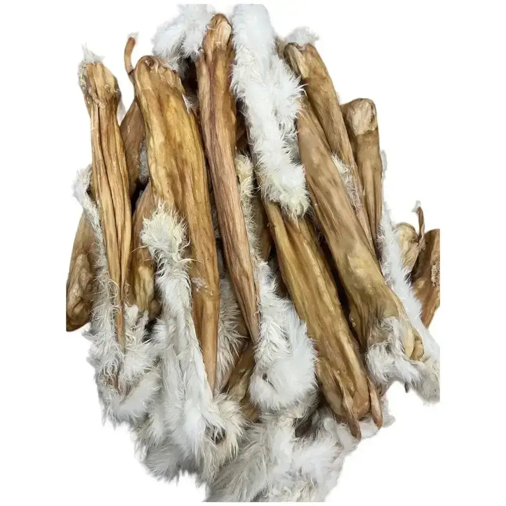 A pile of light brown paddock farm hairy dried rabbit skin treats with fluffy white fur on each end