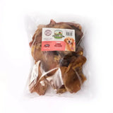 A clear plastic bag of paddock farm pig large brown dried farm pig ears treats called paddock farm pig ears