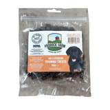 A clear plastic bag of dark brown paddock farm training venison treats with a black puppy image on the front