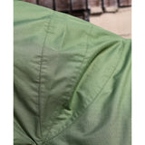 Close-up of a green textured perf combo 0g lightweight turnout rug showing visible stitching on the fabric seams