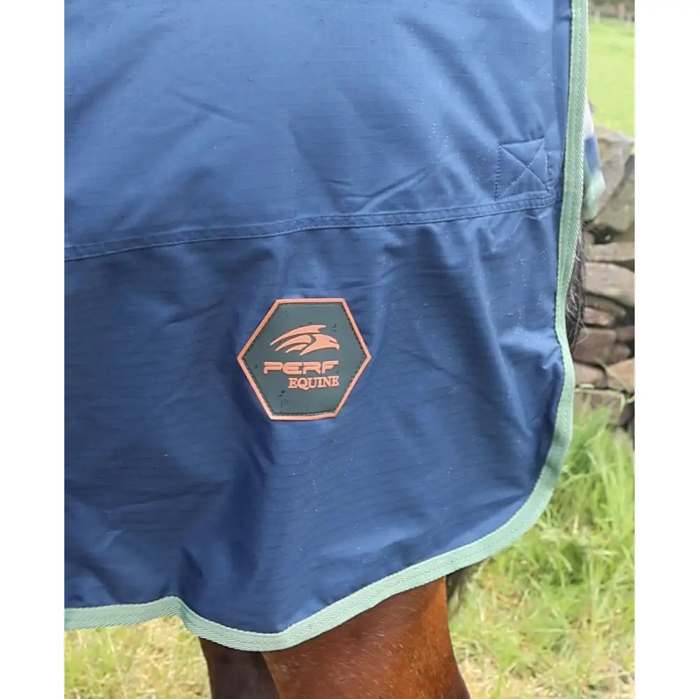 Blue perf detachabale neck turnout rug for horses with green trim and hexagonal logo 300g heavy weight material