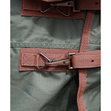 Rust-colored webbing strap with metal buckle and loop on perf detachable neck turnout rug for horses