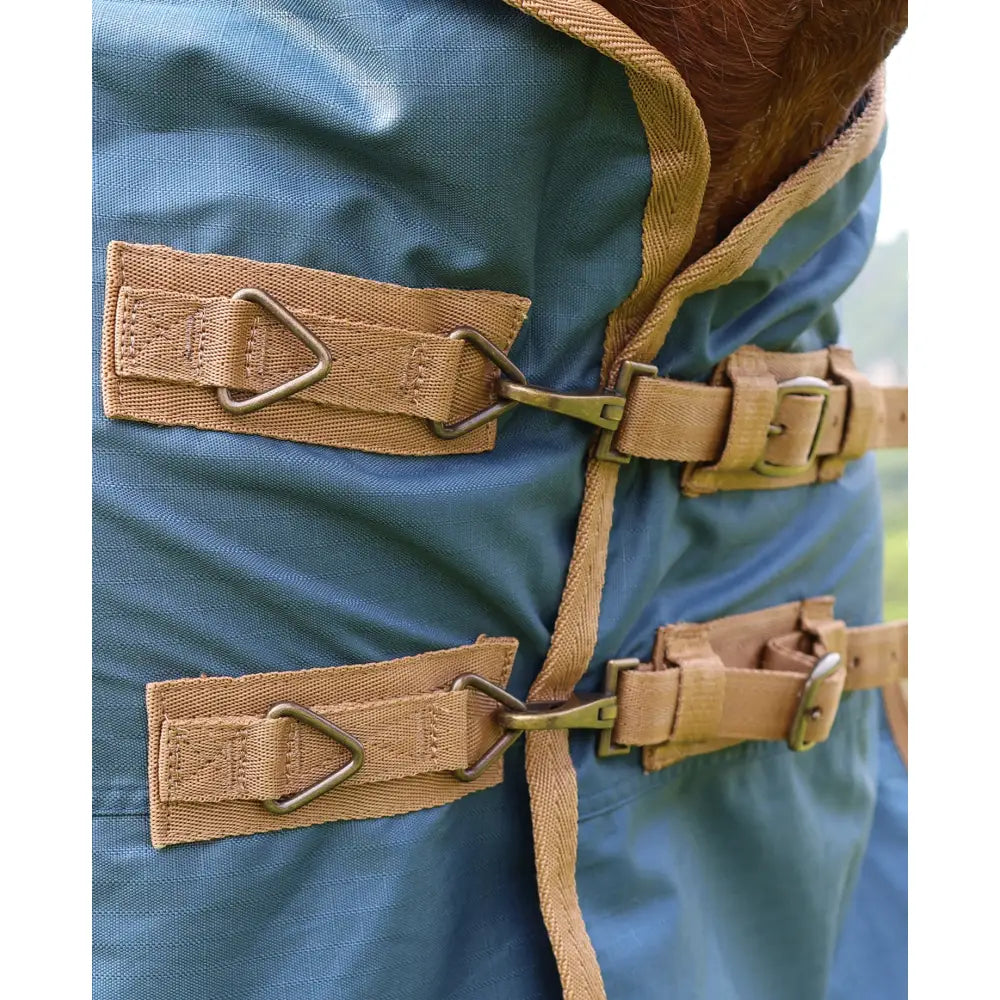 Blue standard 0g lightweight turnout rug for horses with tan fabric straps and metal buckles for secure fit