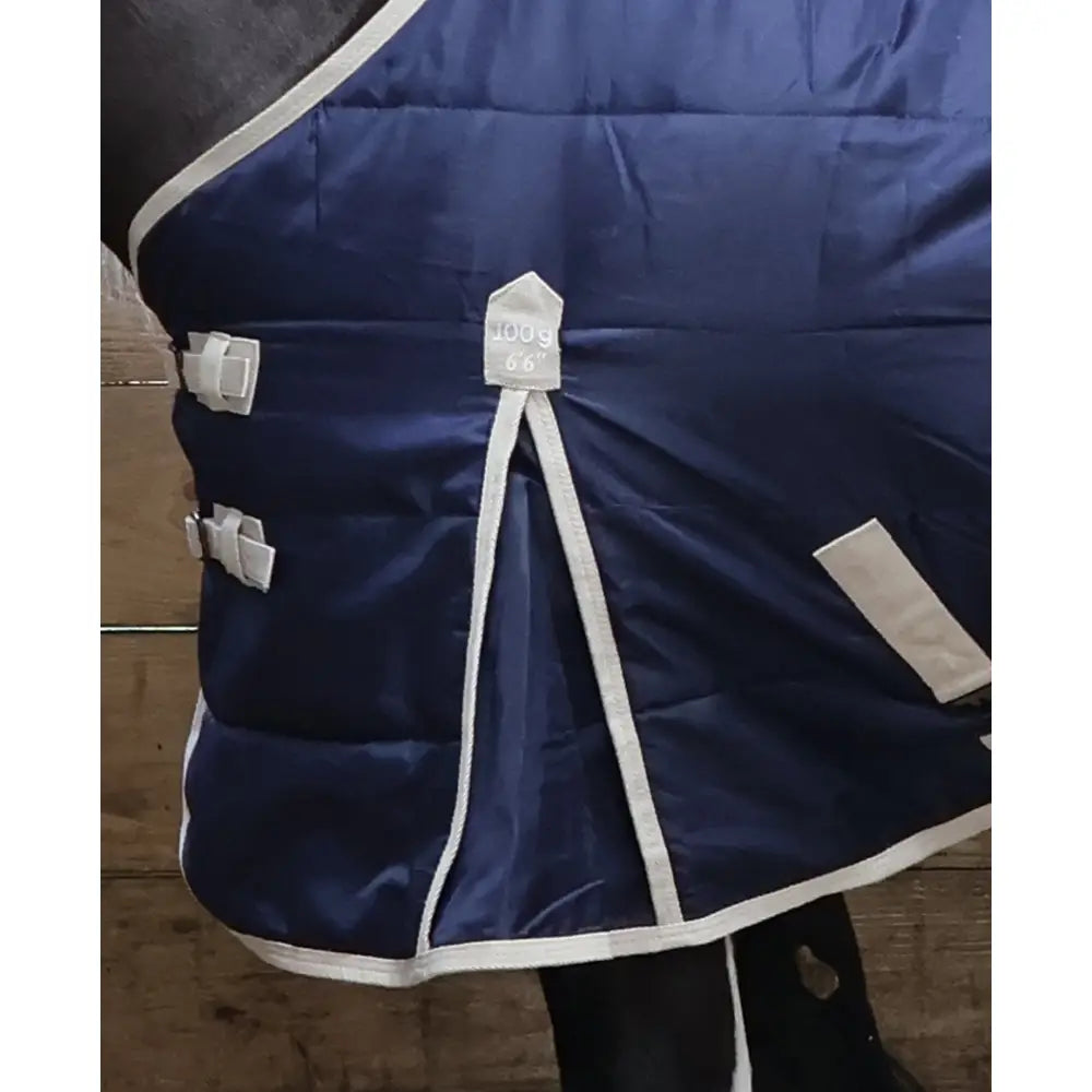 Navy blue quilted perf standard 100g light stable rug with white trim and adjustable straps for horses