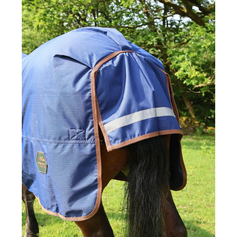 Blue perf standard 100g lightweight turnout rug with brown trim reflective stripe and peak performance logo