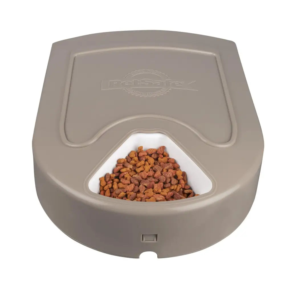 Gray plastic petsafe eatwell five meal pet feeder with white removable tray filled with brown kibble