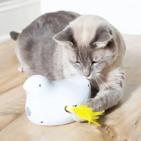 White ceramic petsafe peek-a-bird electronic cat toy with yellow feather attachment and fluttering feathers giving fun play