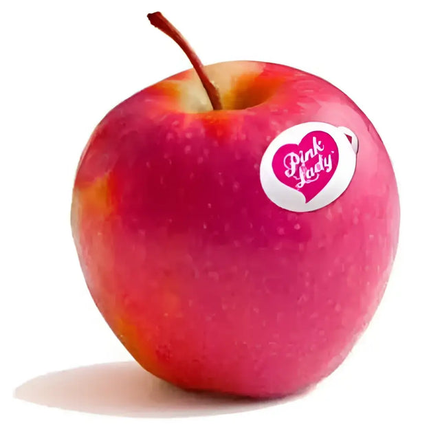 A vibrant red pink lady apple with glossy skin and a small white sticker showing the pink lady logo