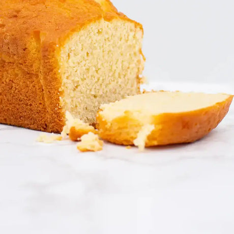 Golden brown pound cake with soft pale interior and crumbly texture resembling white bread loaf