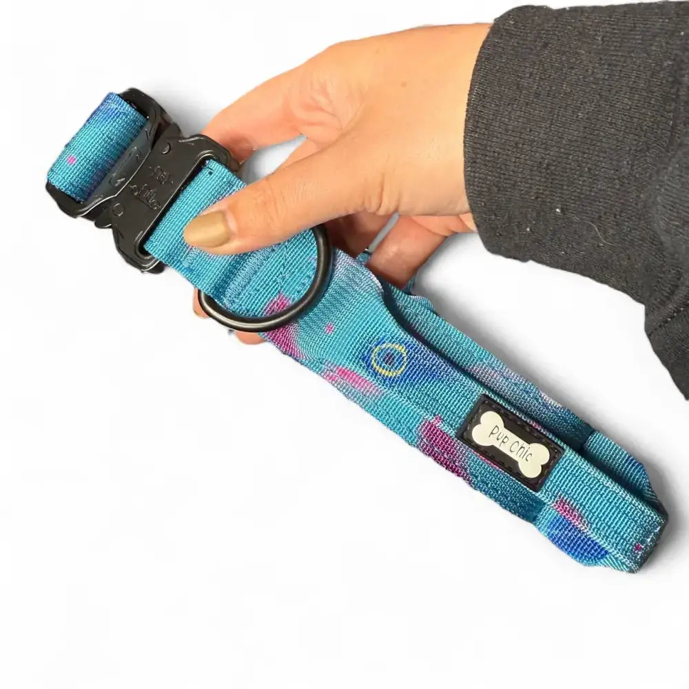 Teal and pink tie-dye peacock power dog collar with tactical black buckle and pup chic brand tag for strong large dogs