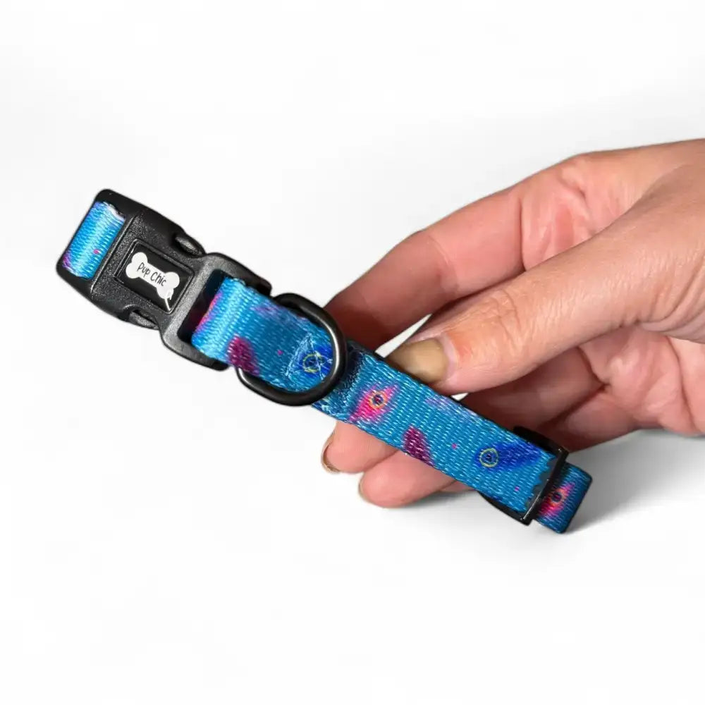 A vibrant blue peacock power dog collar with pink purple fish pattern strong large tactical dog collars by paw chic