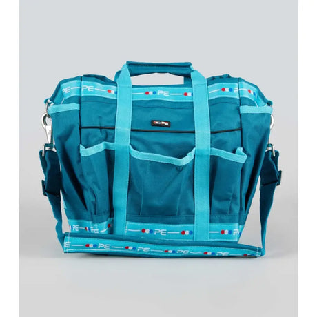 Teal premier equine grooming kit bag with multiple pockets and repeating pe logo pattern accented by red white and blue dots