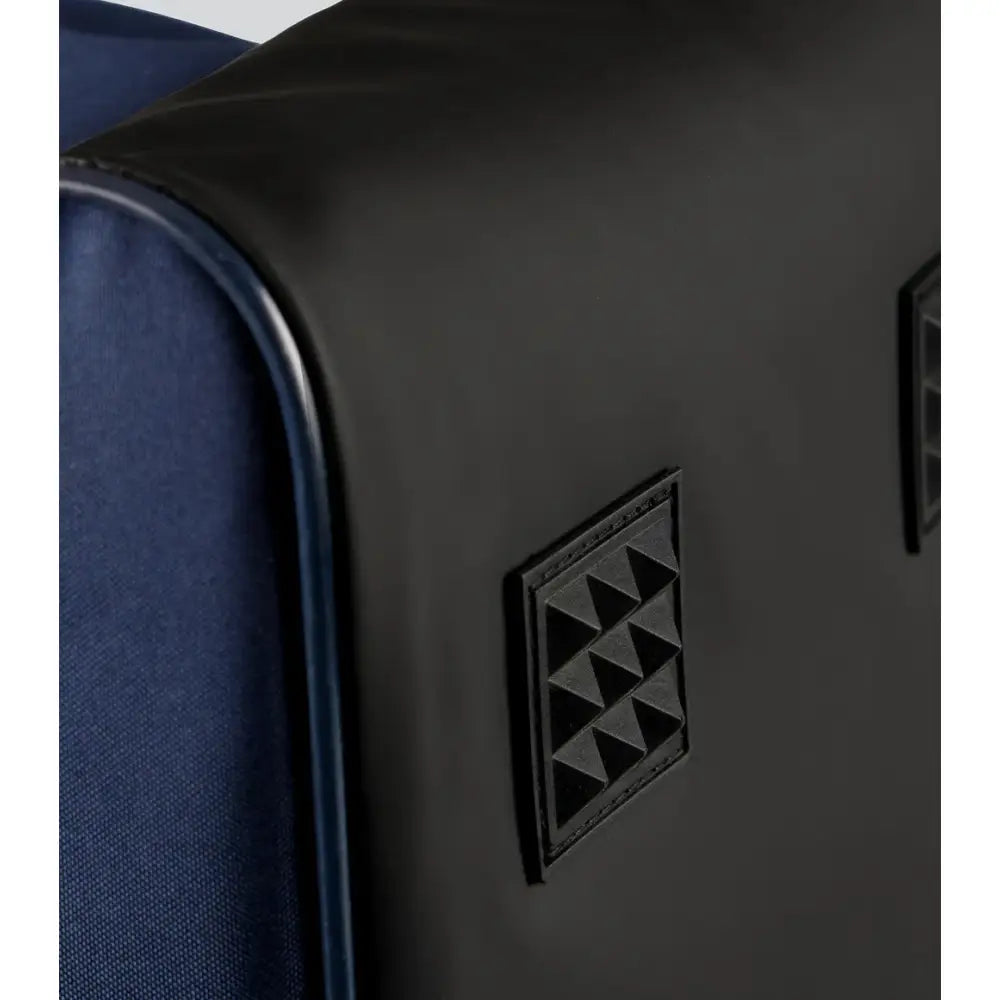 Black leather patch with embossed triangles on navy fabric of premier equine team tall boot bag