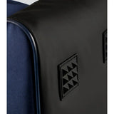 Black leather patch with embossed triangles on navy fabric of premier equine team tall boot bag