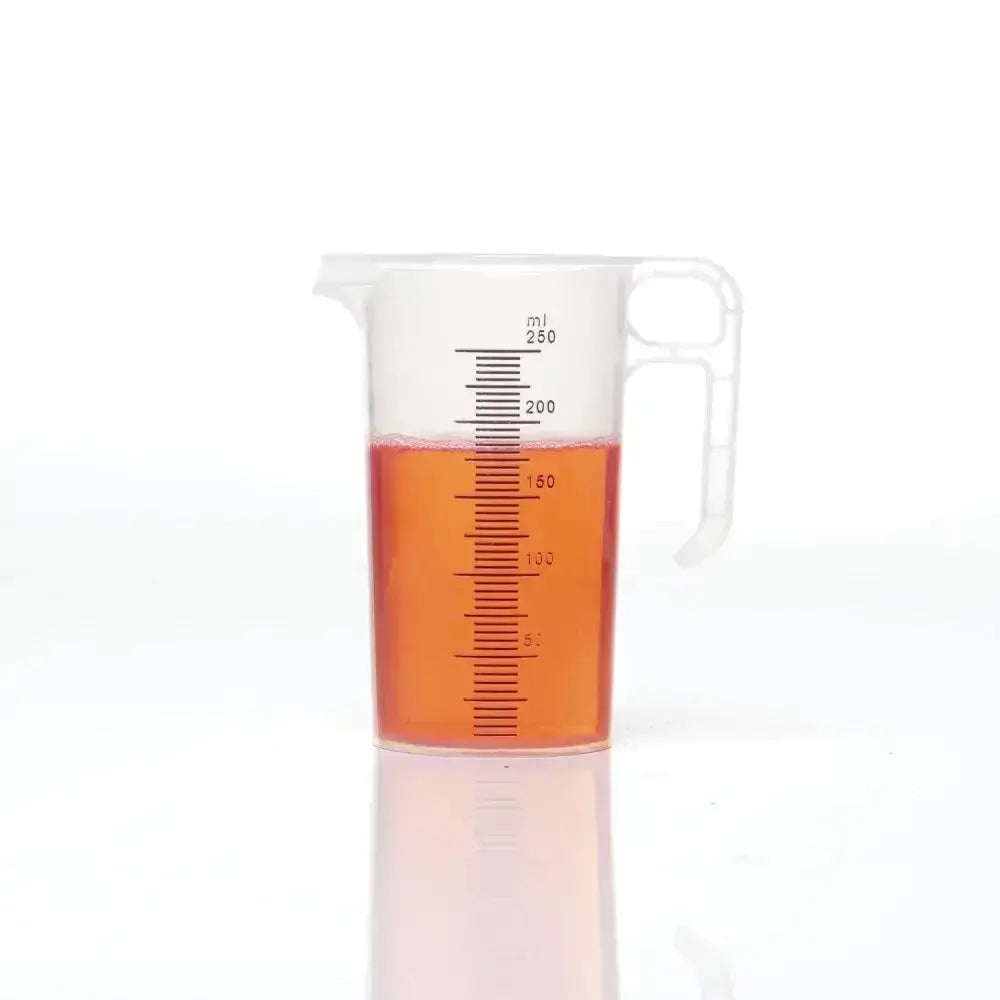Transparent plastic pro-measures pro-jug with white handle and black ml markings filled halfway with orange liquid designed for everyday commercial durability