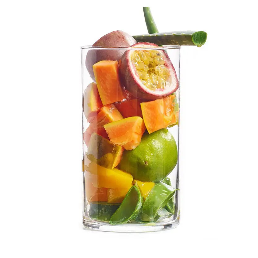 A clear glass of projuice passion storm with orange papaya, passion fruit, lime, and cucumber pieces, perfect after barnstaple equestrian workouts